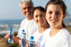 fit family with water bottle after exercise